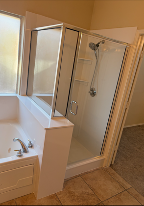 Semi-frameless glass shower enclosure with modern hardware in a Dallas bathroom
