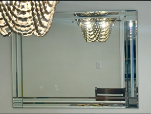 Custom wall mirror installation with beveled edges in a Plano home